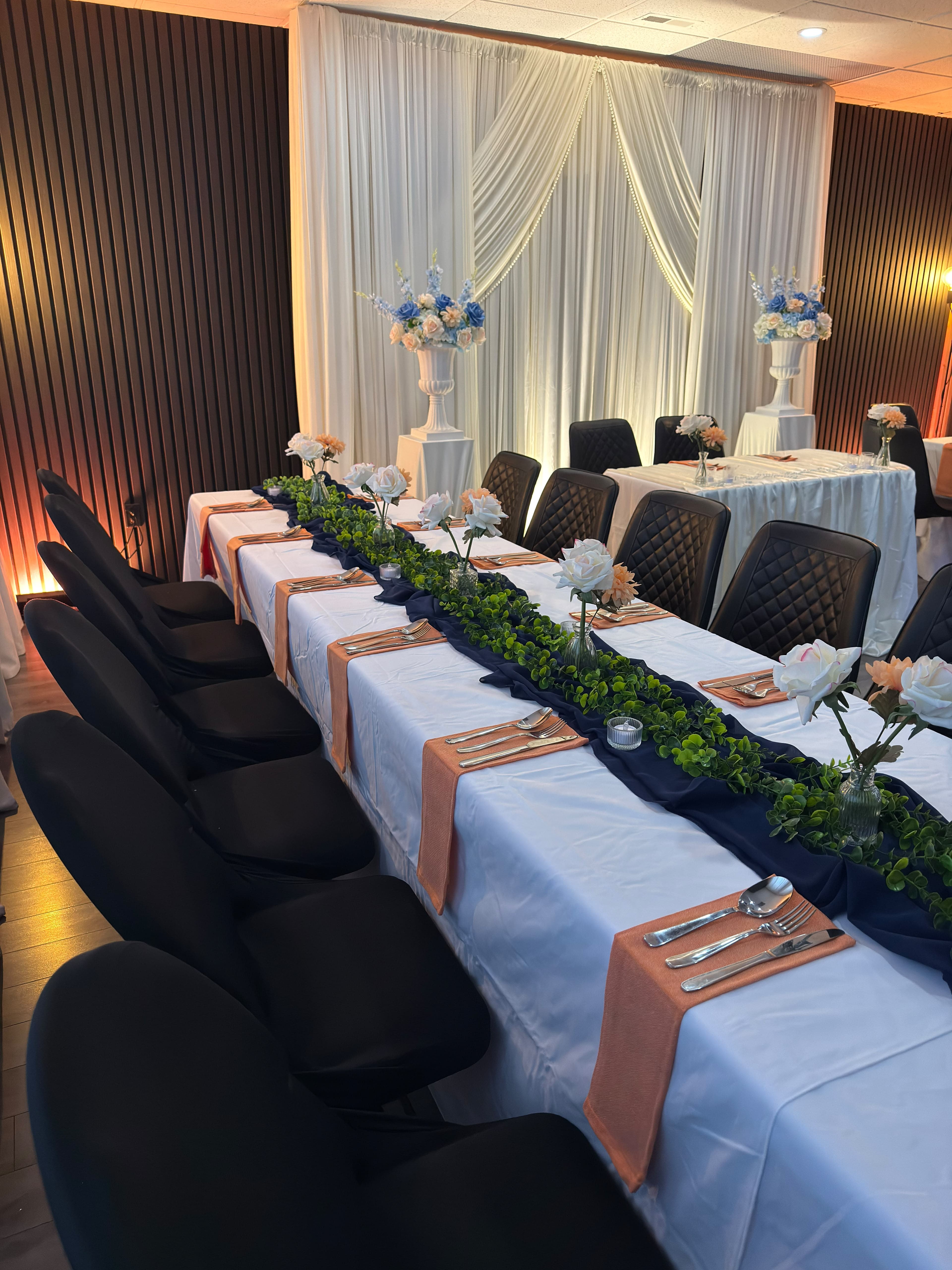 A decorated wedding table with flowers and place settings at KLAS Studio